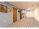 Spacious basement area with neutral carpet and walls, adjacent to a full bathroom at 6006 Regency Dr, Columbus, IN 47203