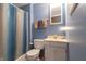 Cozy bathroom with blue walls, shower and tub combo, and a white vanity at 6006 Regency Dr, Columbus, IN 47203