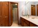Bathroom featuring a single sink vanity, a large mirror and connecting bathroom at 6006 Regency Dr, Columbus, IN 47203