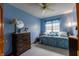 Blue bedroom with a daybed, dresser, and a soft, inviting ambiance at 6006 Regency Dr, Columbus, IN 47203
