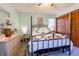 Cozy bedroom featuring a decorative iron bed frame and light green walls at 6006 Regency Dr, Columbus, IN 47203