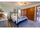 Spacious bedroom showing a ceiling fan, decorative bed frame, and closet space at 6006 Regency Dr, Columbus, IN 47203