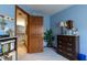 Bedroom featuring blue walls with connecting hallway to another bedroom at 6006 Regency Dr, Columbus, IN 47203