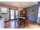 Cozy dining room with wood floors, a round table with chairs, hutch, and French doors leading to the exterior at 6006 Regency Dr, Columbus, IN 47203