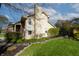 Well-maintained home featuring a neat lawn, stone pathway, and siding, complemented by surrounding trees under a sunny sky at 6006 Regency Dr, Columbus, IN 47203