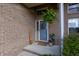 Inviting front entrance featuring a blue door with wreath, brick facade, and potted plants creating a welcoming atmosphere at 6006 Regency Dr, Columbus, IN 47203