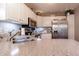 Kitchen featuring stainless steel refrigerator, white cabinets, granite countertops, and stainless steel sink at 6006 Regency Dr, Columbus, IN 47203