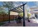 Outdoor patio with a pergola, stone flooring, dining table, and string lights for comfortable entertaining at 6006 Regency Dr, Columbus, IN 47203