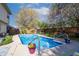 Backyard pool with lounge area, landscaping and privacy fence at 6006 Regency Dr, Columbus, IN 47203