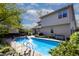 Inviting backyard pool area with landscaping, seating and privacy at 6006 Regency Dr, Columbus, IN 47203