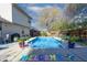 Relaxing backyard pool featuring landscaping, comfortable lounge area and seating at 6006 Regency Dr, Columbus, IN 47203