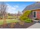 Backyard view overlooking a serene pond, complemented by lush landscaping, perfect for relaxation at 6045 Channel Dr, Columbus, IN 47201