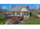A home boasts a large deck and screened in patio overlooking a beautifully landscaped backyard at 6045 Channel Dr, Columbus, IN 47201