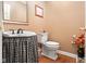 Powder room featuring a pedestal sink with checkered skirt and modern toilet at 6045 Channel Dr, Columbus, IN 47201