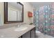 This cozy bathroom boasts a neutral color palette, a speckled countertop, and a decorative shower curtain at 6045 Channel Dr, Columbus, IN 47201