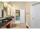 Bathroom vanity with a view to a bedroom with a tray ceiling in the background at 6045 Channel Dr, Columbus, IN 47201