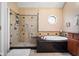 Elegant bathroom featuring a glass-enclosed shower, a soaking tub, and stylish fixtures at 6045 Channel Dr, Columbus, IN 47201