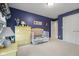 bedroom with blue walls, and yellow furniture including a crib and dresser at 6045 Channel Dr, Columbus, IN 47201