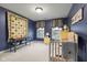 ' bedroom featuring a crib, and blue walls with window decorations at 6045 Channel Dr, Columbus, IN 47201