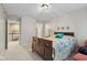 Spacious bedroom featuring neutral tones, a wooden bed, and a glimpse into another room at 6045 Channel Dr, Columbus, IN 47201