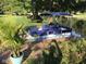 View of boat on the water with a flower bush and palm tree on the dock at 6045 Channel Dr, Columbus, IN 47201