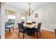 Elegant dining room with hardwood floors, chandelier, large windows and a decorative table setting at 6045 Channel Dr, Columbus, IN 47201