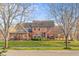 Attractive exterior view of two story brick home with a well maintained lawn and mature trees at 6045 Channel Dr, Columbus, IN 47201