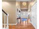 Grand foyer with high ceilings, hardwood floors, chandelier, and elegant staircase at 6045 Channel Dr, Columbus, IN 47201