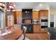Spacious kitchen with custom cabinets, stainless steel appliances, and a stylish chandelier over a dining area at 6045 Channel Dr, Columbus, IN 47201