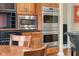 This kitchen features stainless steel appliances, including double ovens and a microwave, with custom wood cabinetry at 6045 Channel Dr, Columbus, IN 47201