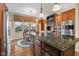 Open kitchen layout with a granite island, stainless appliances, and a cozy dining area with a view at 6045 Channel Dr, Columbus, IN 47201