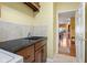 Laundry room with granite countertops, tiled backsplash, and convenient access to the main living spaces at 6045 Channel Dr, Columbus, IN 47201