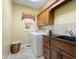 Functional laundry room with a washer and dryer, ample cabinet space, and a granite countertop at 6045 Channel Dr, Columbus, IN 47201