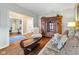 Comfortable living room featuring hardwood floors, an antique cabinet, and elegant furniture at 6045 Channel Dr, Columbus, IN 47201