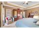 Inviting main bedroom featuring a spacious layout, tray ceiling, and a cozy sitting area by the window at 6045 Channel Dr, Columbus, IN 47201