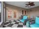 Relaxing porch featuring comfortable seating, a ceiling fan, and a charming black-and-white patterned floor at 6045 Channel Dr, Columbus, IN 47201