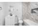 Modern bathroom with a sleek vanity, marble tile accent wall, and a bathtub at 650 S Lyons Ave, Indianapolis, IN 46241