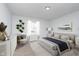 Cozy bedroom with natural light, neutral color palette, plush carpeting and modern décor at 650 S Lyons Ave, Indianapolis, IN 46241