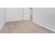 Bedroom with neutral walls, carpet flooring, and a view into the hall at 650 S Lyons Ave, Indianapolis, IN 46241