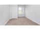 Bedroom featuring neutral walls, carpet flooring, a closet, and a large window at 650 S Lyons Ave, Indianapolis, IN 46241