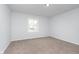 Bright bedroom with a large window, carpet flooring, and neutral paint at 650 S Lyons Ave, Indianapolis, IN 46241