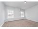 Bright bedroom featuring neutral walls, carpet flooring, and natural light through large windows at 650 S Lyons Ave, Indianapolis, IN 46241