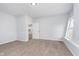 Bright bedroom with neutral walls, carpet flooring, and a view into the ensuite bathroom at 650 S Lyons Ave, Indianapolis, IN 46241