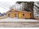 Charming one-story home with a yellow door, wood siding, and a well-maintained front yard at 650 S Lyons Ave, Indianapolis, IN 46241