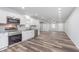 Open concept kitchen with stainless steel appliances, white cabinets, and modern countertops at 650 S Lyons Ave, Indianapolis, IN 46241