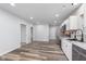 Modern eat-in kitchen featuring stainless appliances, a stainless sink, and hardwood flooring at 650 S Lyons Ave, Indianapolis, IN 46241