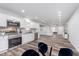 Open kitchen and living space with stainless steel appliances, white cabinetry, and hardwood floors at 650 S Lyons Ave, Indianapolis, IN 46241