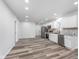 Open-concept kitchen features stainless steel appliances, white cabinets, and sleek gray countertops at 650 S Lyons Ave, Indianapolis, IN 46241