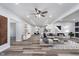 Open-concept living room provides plentiful light and a contemporary aesthetic, with neutral tones and hardwood flooring at 650 S Lyons Ave, Indianapolis, IN 46241