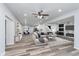 Open-concept living room featuring wood floors, recessed lighting, and an accent wall with fireplace and television at 650 S Lyons Ave, Indianapolis, IN 46241